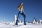 Sexy blonde girl wearing winter glamour sequin bikini and winter fashionable boots is posing on a sunny day in the mountains