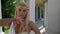 sexy blonde woman is dressed like ancient greek goddess is posing and flirting with camera