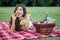 Sexy brunette woman on picnic blanket in the park