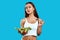 Sexy cheerful woman with a bowl of vegetable salad