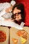 Sexy couple eating pizza in bed at home. Passionate couple. Young lovers. Happy cheerful man and woman feeding each