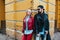 Sexy couple in leather jacket and sunglasses posing over wall in city