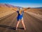 Sexy curvy woman stands on lane of Badwater Road, Death Valley, California