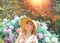 Sexy and dreamy blond girl in a summer elegant dress and hat in nature