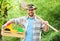 Sexy farmer hold shovel and box with pot. muscular ranch man in cowboy hat. farming and agriculture. Garden equipment