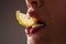 Sexy fruit. Closeup lips with lemons. Vitamin C. Summer refreshment concept. Tea time. Girl with slice of lemon. Macro