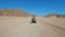 Sexy Girl is Riding a Quad Bike in the Desert of Egypt. Dynamic view in motion.