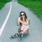 Sexy girl on roller skates sitting on the road and photographed herself.