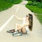 Sexy girl on roller skates sitting on the road and photographed herself.