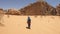 Sexy girl trekking in colorful salwar pants in the desert of Wadi Rum, Jordan