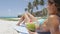 Sexy hot bikini slim body woman drinking healthy coconut water on tropical beach