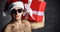 Sexy man hold red christmas present gift box in new year santa hat with naked torso in sunglasses