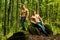 Sexy men with muscular body and bare torso and jeans pants. Fashion portrait of young hot naked guys in forest. Full