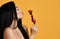 Sexy naked brunette woman kissing smelling eating berries on skewer with berries isolated on yellow. Advertisement concept