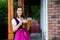 Sexy russian woman in Bavarian dress holding beer mugs.