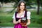 Sexy russian woman in Bavarian dress holding beer mugs.