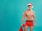 Sexy shirtless Santa Claus on blue background