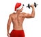 Sexy shirtless Santa Claus with dumbbell