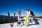 Sexy skier woman in bikini and snowboarder man with bare torso on background of snowy mountains.
