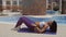 Sexy sporty woman fitness massage with foam roller outdoors