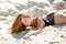 Sexy Summer Girl. Woman lying in sand on beach. Vacation at Paradise. Summetime mood.