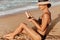 Sexy suntan bikini woman legs relaxing lying down on beach . Beauty skincare sun aging protection body care of tanned skin. Epilat