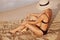 Sexy suntan woman in bikini legs relaxing lying down on beach. Beauty skincare sun aging protection body care of tanned skin. Epil