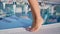 Sexy tanned female feet walking near swimming pool enjoying summer travel vacation close-up