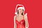 Sexy tanned girl in red swimsuit and christmas hat send thumb up to the camera. Recommend advertising concept. Magazine collage