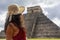 Sexy tourist woman enjoying and visiting the pyramid of Chichen Itza in the Yucatan peninsula