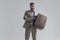 Sexy unshaved man with eyeglasses holding suitcase and posing