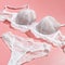 Sexy white lace bra and panties on pink background. Stylish lingerie flat lay square image. Underwear fashion concept