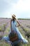 Sexy woman with blond hair in luxurious dress posing in summer flowering lavender field