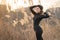 Sexy woman doing stretching and physical activity, sunrise, wheat and nature, meditation, yoga