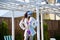 Sexy woman in fashionable raincoat. girl in plastic cap in summer. lady in swimsuit at swimming pool