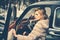 Sexy woman in fur coat. Call girl in vintage car. Travel and business trip or hitch hiking. Retro collection car and