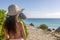 Sexy woman with hat on dolphins beach on a sunny day in the hotel zone of Cancun Mexico. It is a tropical paradisiacal beach.