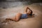 Sexy woman lying on sandy beach near the sea. Sexy body. Tanned skin. Asian woman wearing bikini. Summer concept. Vacation on