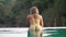 Sexy woman swims in the outdoor pool. Beautiful woman in an outdoor pool in nature