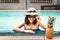 Sexy Woman in Swimsuit is Relaxing in Swimming Pool, Beautiful Woman Wearing Straw Hat and Relax Sunbathe in Poolside on Summer