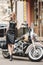 Sexy young elegance woman near old fashioned custom motorcycle. Outdoor lifestyle portrait