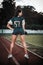 Sexy young sportive girls in t-shirt of rugby football player in action on the stadium. American football woman player stay on