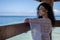 Sexy young woman admiring and thinking about the beauty of the turquoise Caribbean Sea from a pier