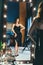 Sexy young woman in elegant cocktail silk black dress dancing and posing in mirror reflection in luxury interior