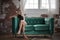 Sexy young woman sits on green sofa