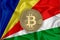 Seychelles flag, bitcoin gold coin on flag background. The concept of blockchain, bitcoin, currency decentralization in the