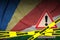 Seychelles flag and Covid-19 quarantine yellow tape. Coronavirus or 2019-nCov virus