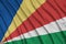 Seychelles flag is depicted on a sports cloth fabric with many folds. Sport team banner