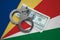 Seychelles flag with handcuffs and a bundle of dollars. Currency corruption in the country. Financial crimes