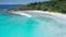 Seychelles La Digue Island. Aerial fly above blue lagoon of most beautiful tropical beach anse Cocos with clear